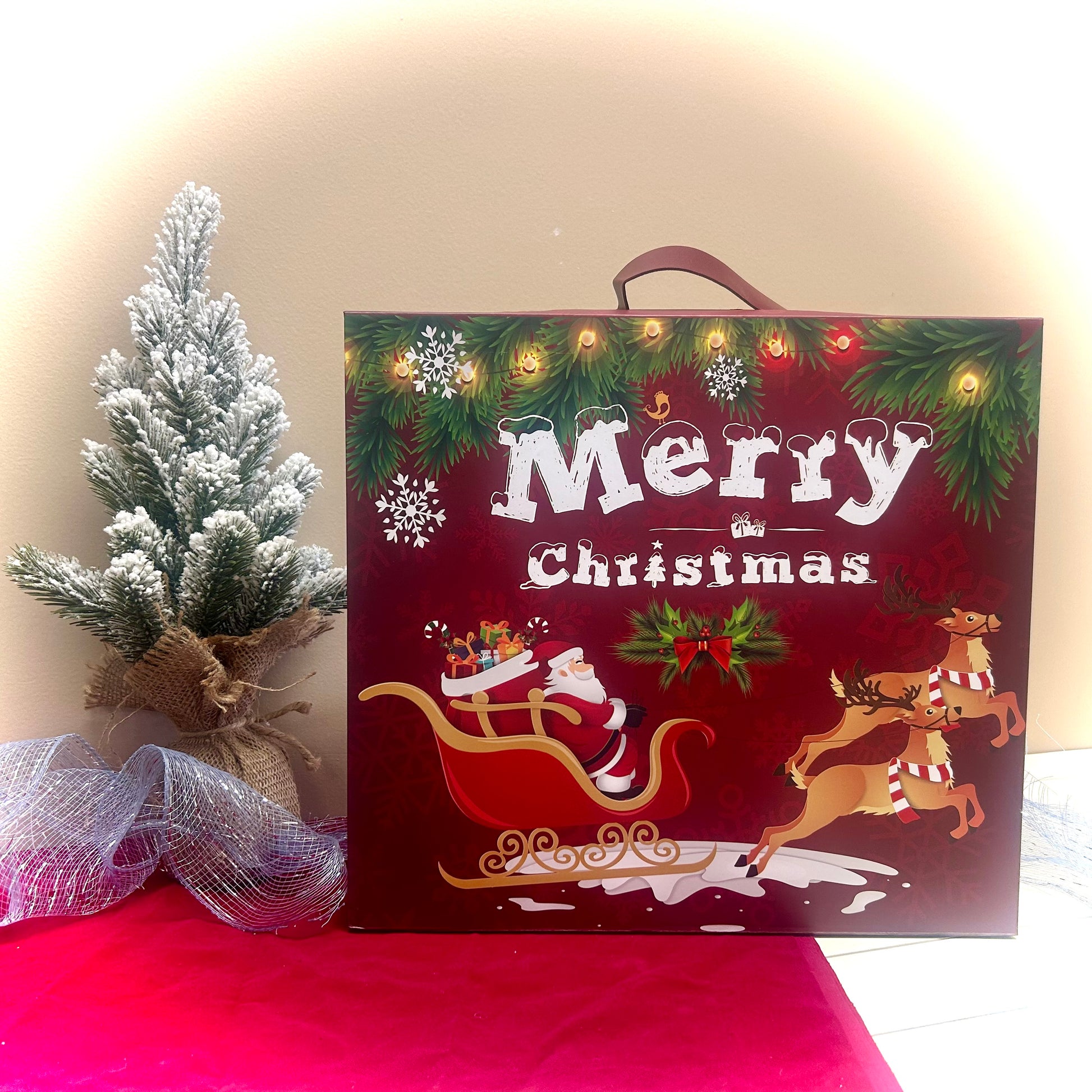 Christmas-themed advent calendar with 'Merry Christmas' text, Santa Claus, and reindeer on a pink surface.