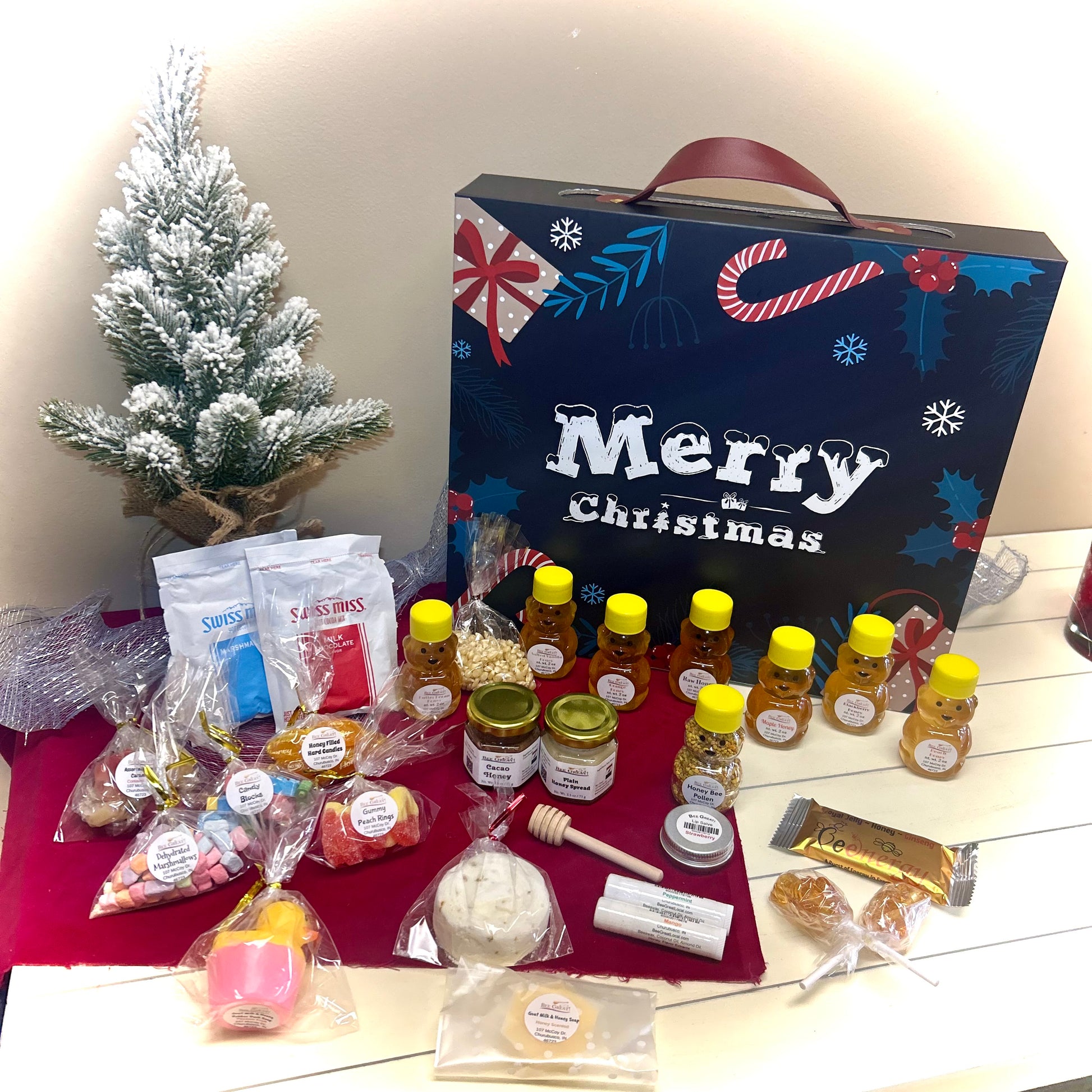 Gourmet gift set with Christmas-themed advent calendar on a wooden surface.