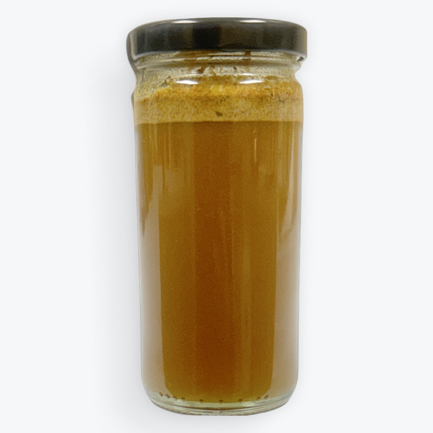 Glass jar with a black lid containing a brownish liquid on a white background