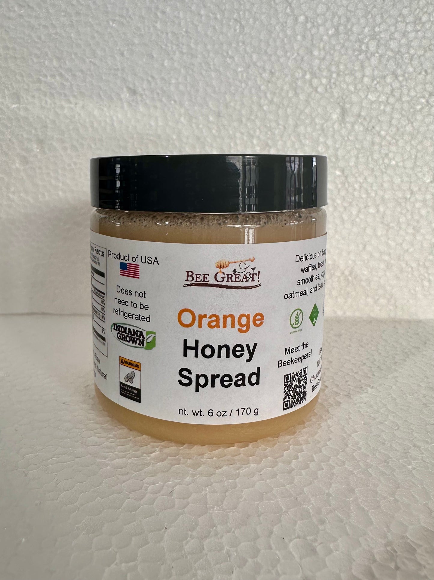 bee great orange honey spread (creamed honey) in a plastic jar with black screw cap